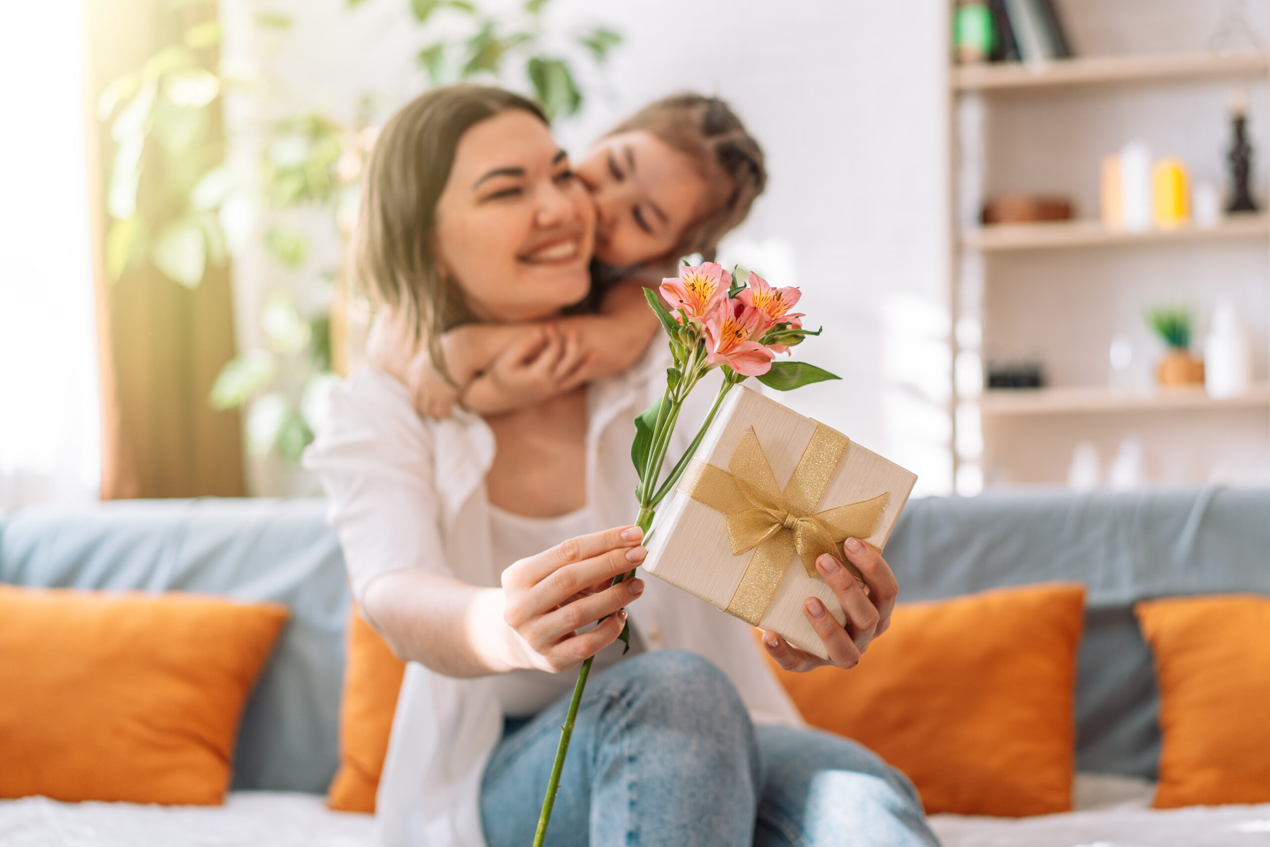 Daughter hugged her mother and gave a gift and flowers, mother’s day