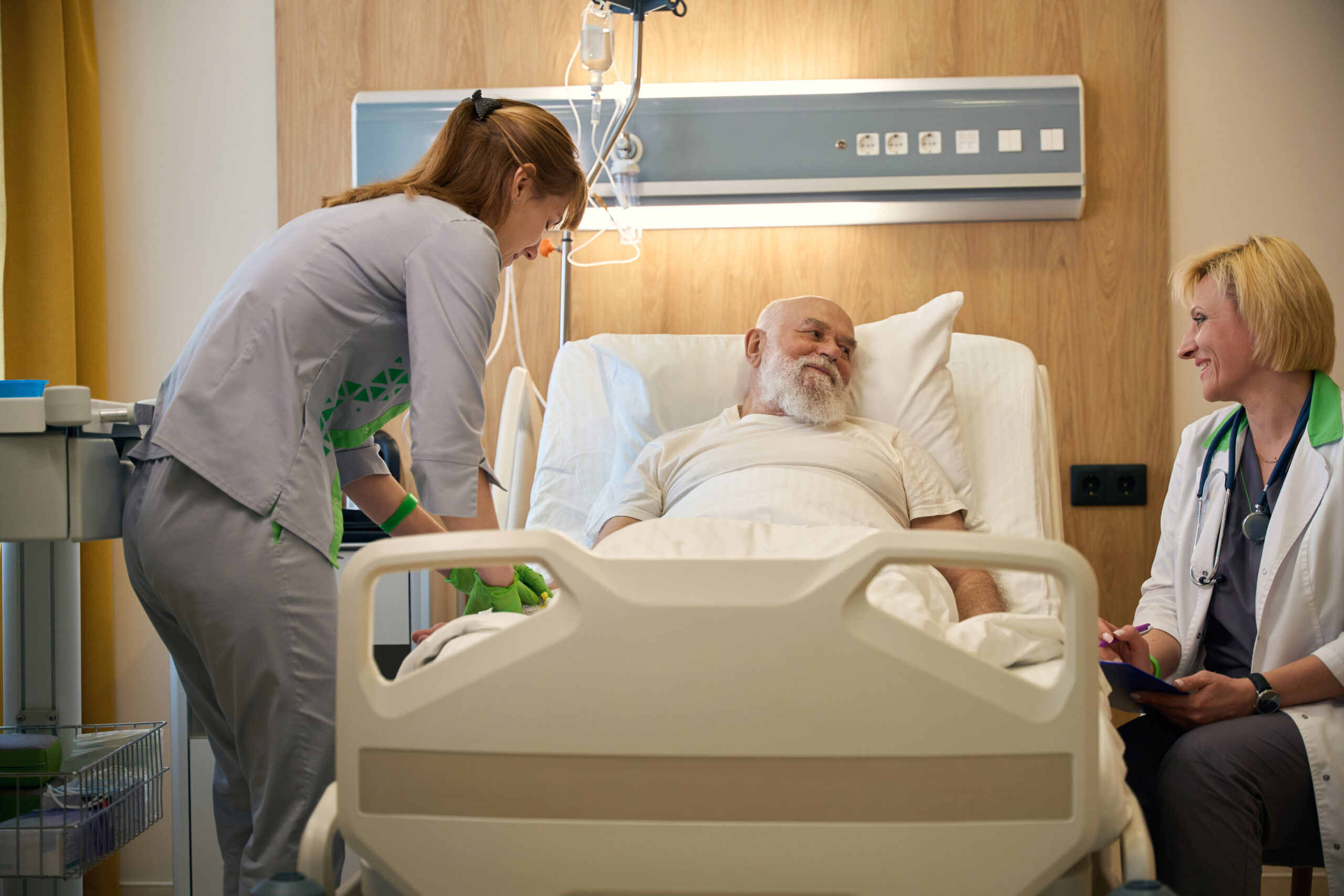Three people talking in a hospital room