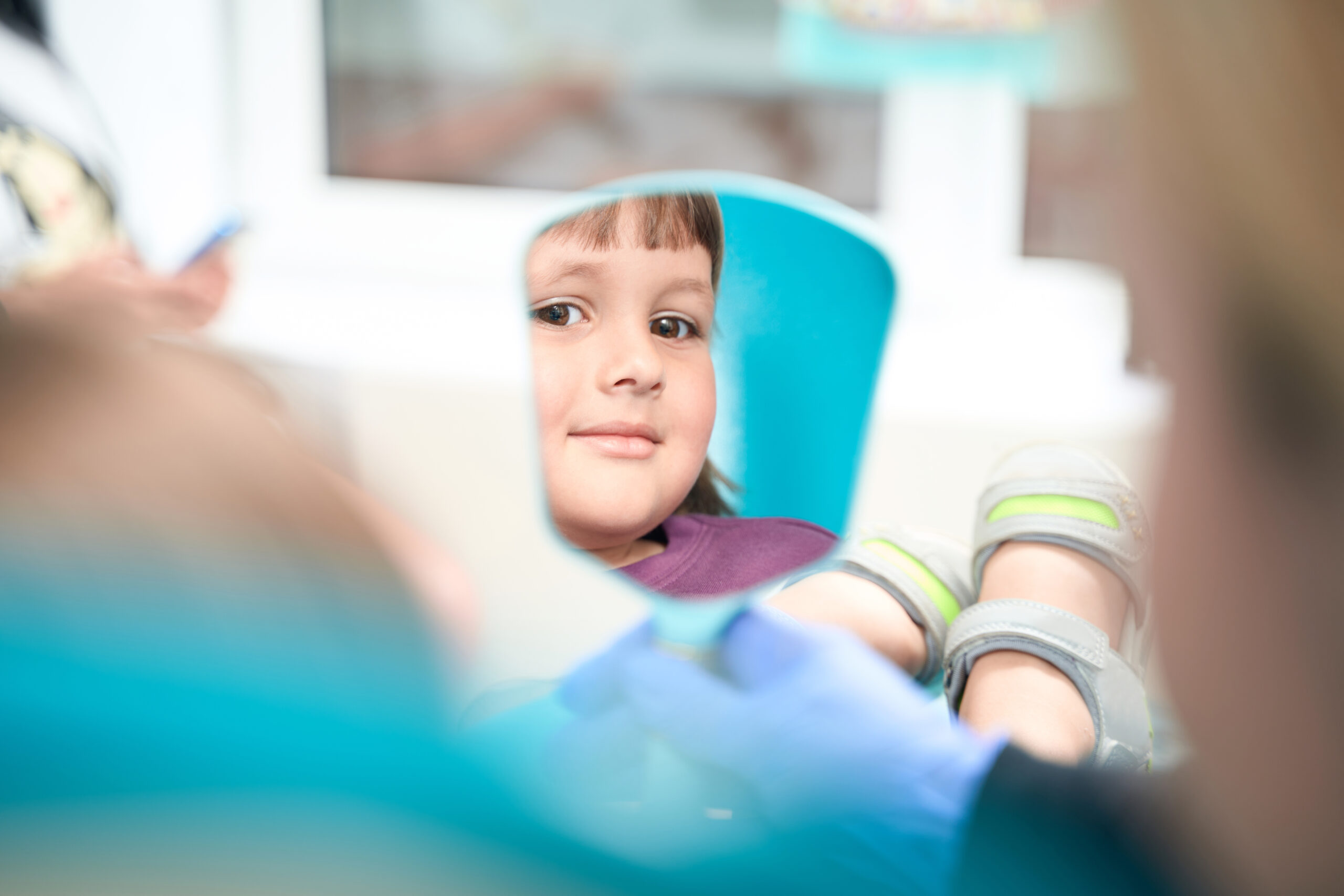 Calm female child sitting in dentist office