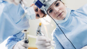 Dentist and dental nurse treating patient, personal perspective