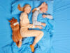 Top view of family couple and their pet sleep peacefully in bed see sweet dreams lying closely to each other have good friendly relationships. Mature woman and man have rest in bedroom with dog