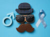 Blue ribbon with mustache, glasses and hat, Movember concept