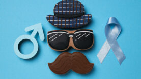 Blue ribbon with mustache, glasses and hat, Movember concept