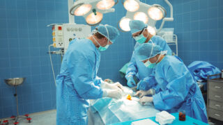 Team of surgeons performing operation in operation theater