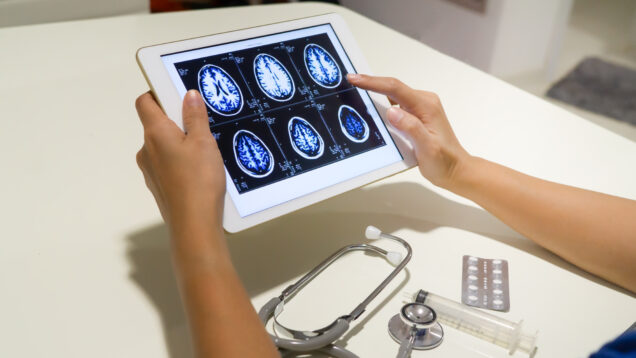 doctor diagnose brain x-ray image on digital tablet for diagnose Herniated disc disease with radiologic technologist team.