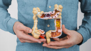 Man suffering from constipation and abdominal pain. Treatment of colitis, flatulence, indigestion