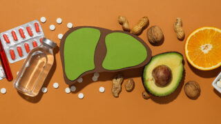 Paper mockup of liver, pills and food on orange background, top