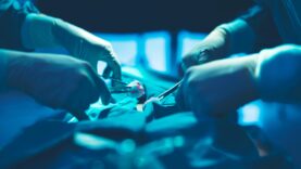 In a operating room, a doctor or medical team is performing a su