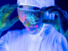 Portrait of man doctor in protective clothes in ultraviolet neon light during coronavirus pandemic.